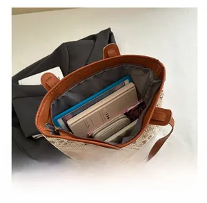 Detail view showing large capacity interior of the woven tote bag with daily essentials