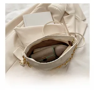 Internal view of beige bucket bag showing capacity for phone, wallet and cosmetics