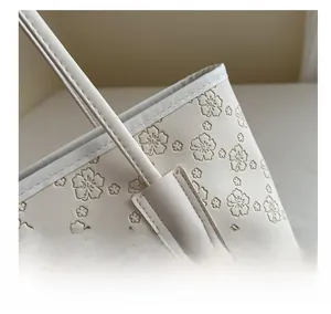 Detailed macro view of floral embossed faux leather tote bag with precise stitching