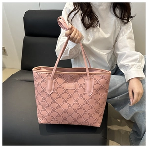 Detail of pink floral tote bag showing high-capacity design and reinforced long handles