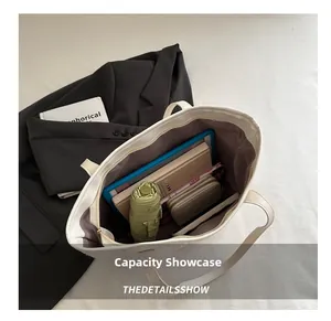 Top view of large white tote bag showing spacious interior with tablet and daily items