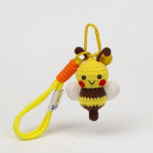 Detailed handmade crochet bee keychain with yellow bell and sturdy metal carabiner hook