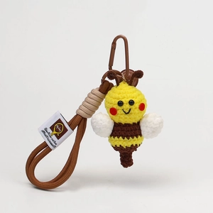 Detailed macro view of the handmade yellow crochet bee keychain accessory