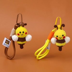 Handmade crochet bee keychains in yellow and brown with woven strap and metal clip