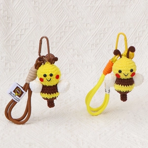 Handmade crochet bee keychains in brown and yellow with cute wings and metal clips