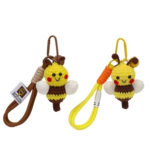 Handmade crochet bee keychains in yellow and brown colors with knit hanging straps