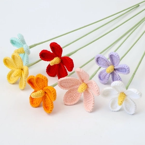 Handmade crochet flowers in multiple colors with green stems on a clean white background