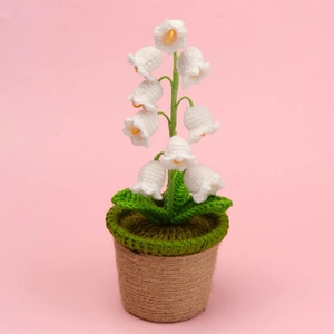 Detailed view of hand-knitted Lily of the Valley in a brown twine-wrapped flowerpot
