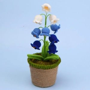 Macro shot of handmade crochet lily of the valley in blue and white with jute pot