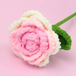 Detailed close-up of handmade crochet pink rose flower with soft chenille yarn texture