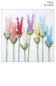 Detailed view of handmade crochet lavender flowers in eight vibrant colors on white background