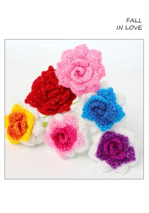 Macro detail of handmade crochet roses in multiple colors with shimmering yarn texture