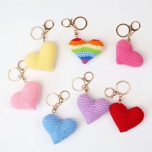 Handmade crochet heart keychains in seven vibrant colors with gold metal rings and clasps