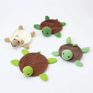 Handmade crochet animal coasters set featuring cute green turtles and a white sheep