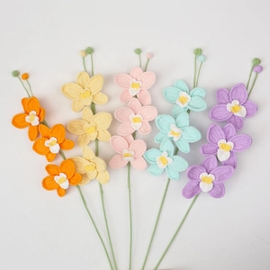 Detailed knit texture of five colorful handmade crochet orchid bouquets on white background