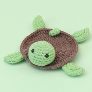 Handmade crochet turtle coaster and doll in green and brown yarn for home decor