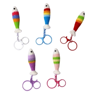Five handmade crochet rainbow fish keychains with colorful striped cotton yarn patterns