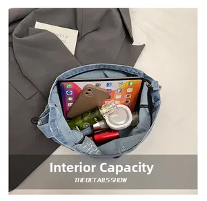 Spacious interior of blue denim tote bag holding tablet and cosmetics for daily commute