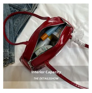 Macro view of the red patent leather bag interior showing spacious capacity for cosmetics