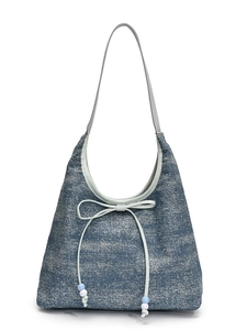 Blue denim tote bag with bow detail and beaded accents, minimalist commuter style
