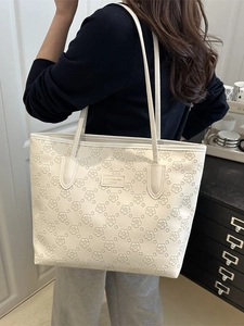 White large capacity tote bag with floral embossed patterns and shoulder straps