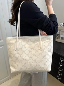 Chic beige tote bag with embossed floral patterns for stylish daily commuting and work