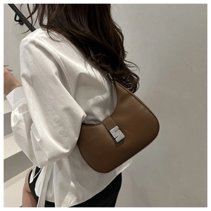 Detailansicht einer braunen Hobo-Tasche aus Kunstleder mit silberner geometrischer Schnalle