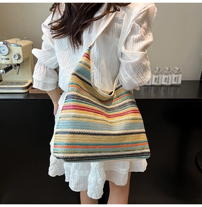 Close-up of colorful striped woven tote bag with vibrant textures and shoulder strap