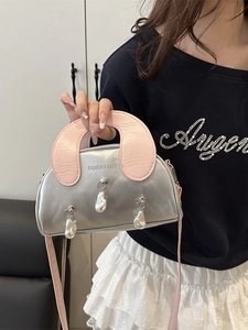 Silver shell-shaped crossbody bag with pink straps and baroque pearl charms on main front