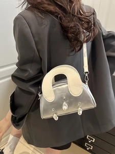 Silver metallic shell handbag with pearl charms and cream handle for women's crossbody wear