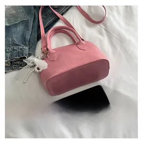 Pink Boston lace handbag detail with pearl charm and adjustable shoulder strap