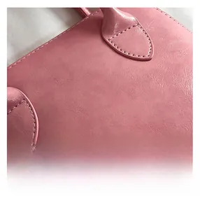 Detail shot of the pink leather seashell bag showing precise stitching and fine texture