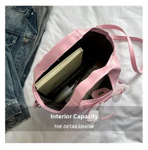 Top view showing large capacity of pink handbag with notebook and daily essentials