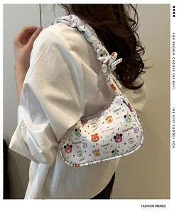 Detail view of large capacity white canvas underarm bag with cute cartoon animal prints