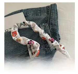 Detail of ruched strap with colorful cartoon animal prints on casual canvas shoulder bag
