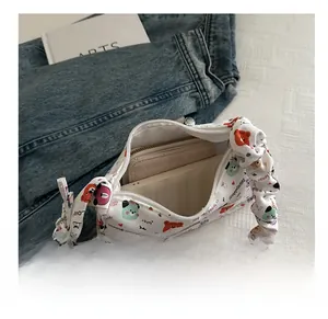Interior view showing the capacity of the cartoon printed white hobo bag with ruched handle