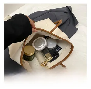 Internal view of a spacious tote bag showing storage for makeup, phone, and perfume