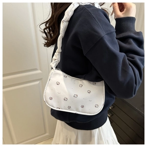 Detailed view of white canvas underarm bag with cute animal print and ruffled shoulder strap