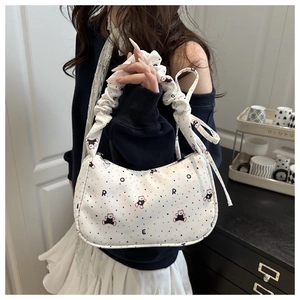 Detail of white pleated hobo bag featuring colorful polka dots and cute bear pattern