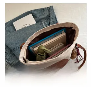 Interior view of spacious canvas tote bag showing storage for tablet, books, and umbrella