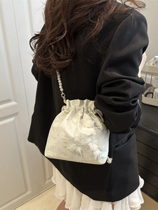 Elegant pearl strap bucket bag with floral lace embroidery and drawstring closure