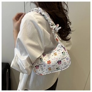 Detailed close-up of white hobo bag featuring colorful cartoon bear patterns and text