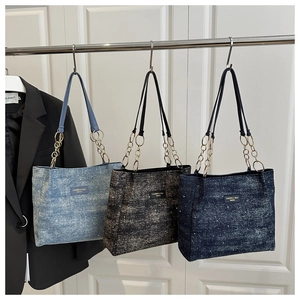 Three denim texture tote bags in blue and black with stylish metal chain leather handles
