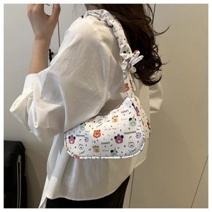 Detail of white shoulder bag with colorful cartoon bear prints and ruffled strap design