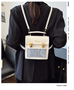 Detail of white faux leather backpack with gold embroidery and mesh front pocket