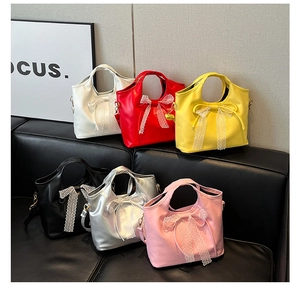 Detail showing six colorful glossy faux leather handbags with lace bow decorations