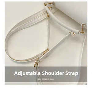 Close-up of adjustable white leather shoulder strap with premium gold metal hardware