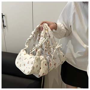 Detail of canvas underarm bags with cute animal prints and ruched handle design