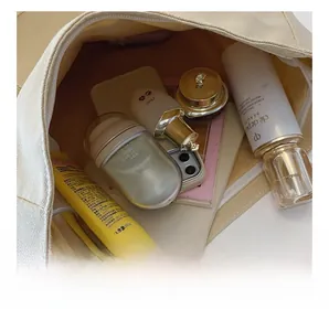 Spacious interior of a beige canvas tote bag showing large capacity for essentials