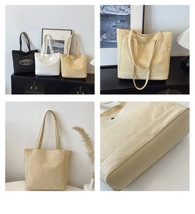 Detail of multi-color canvas tote bags showing spacious interior and fine bottom stitching